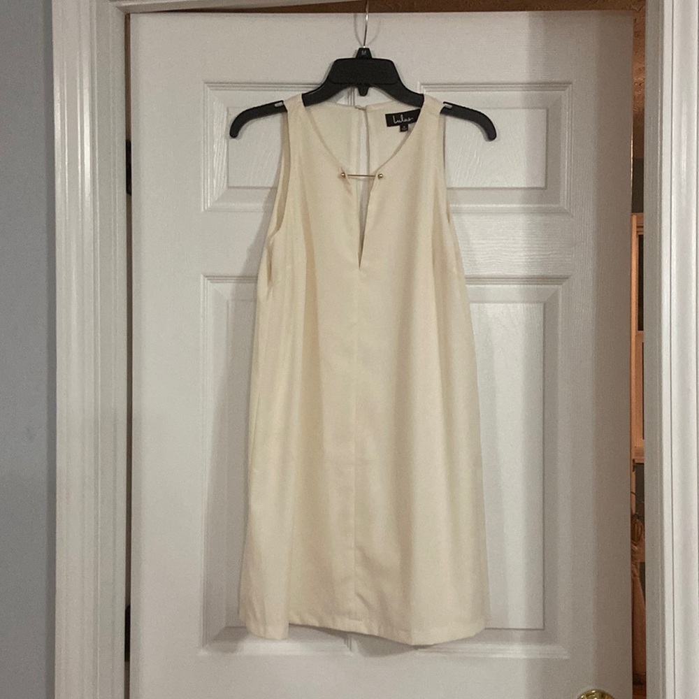 Cream dress with deep v cut.